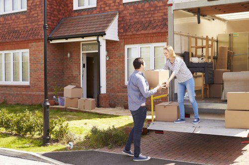 Removal van and moving crew working in a Clapham residential street