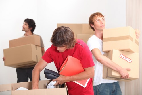 Professional movers handling desks and IT equipment during an office relocation