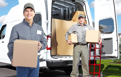 Movers carrying furniture through a Clapham property